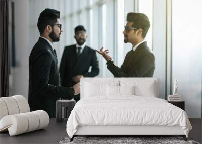 Two businessmen discussing at office during business meeting in front of business partner before decision. Wall mural